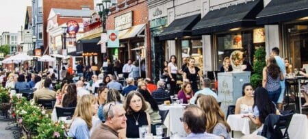 Outdoor dining on Federal Hill in Providence, Rhode Island, during Al Fresco on the Hill, with restaurants and outdoor seating along Atwells Avenue.