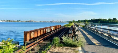 A scenic view of the Providence skyline as seen from the East Bay Bike Path along the Providence River.
