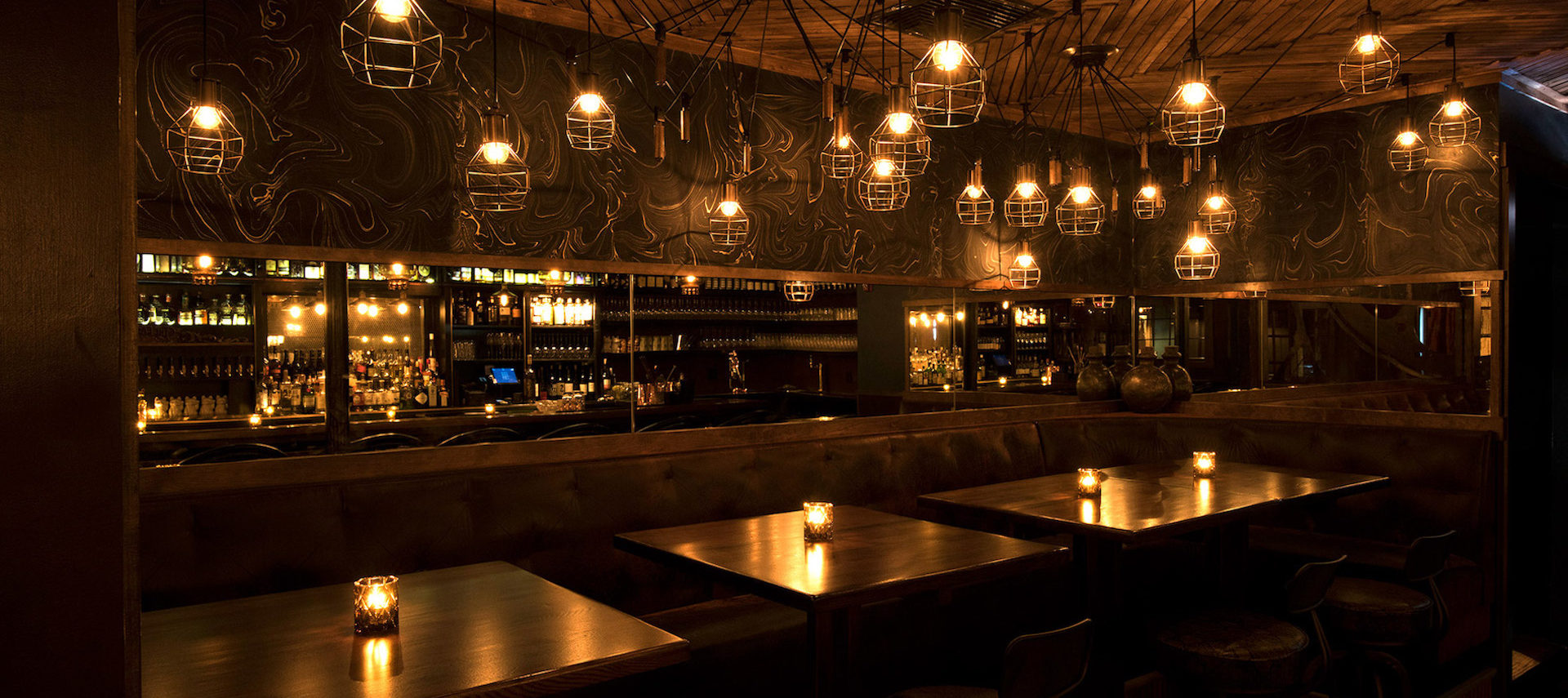 The mellow glow of industrial lighting over the dining tables.