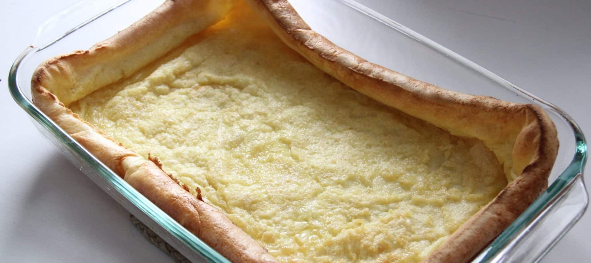 A large custard looking pancake made in the oven using a 9x13 glass pan.