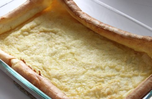 A large custard looking pancake made in the oven using a 9x13 glass pan.