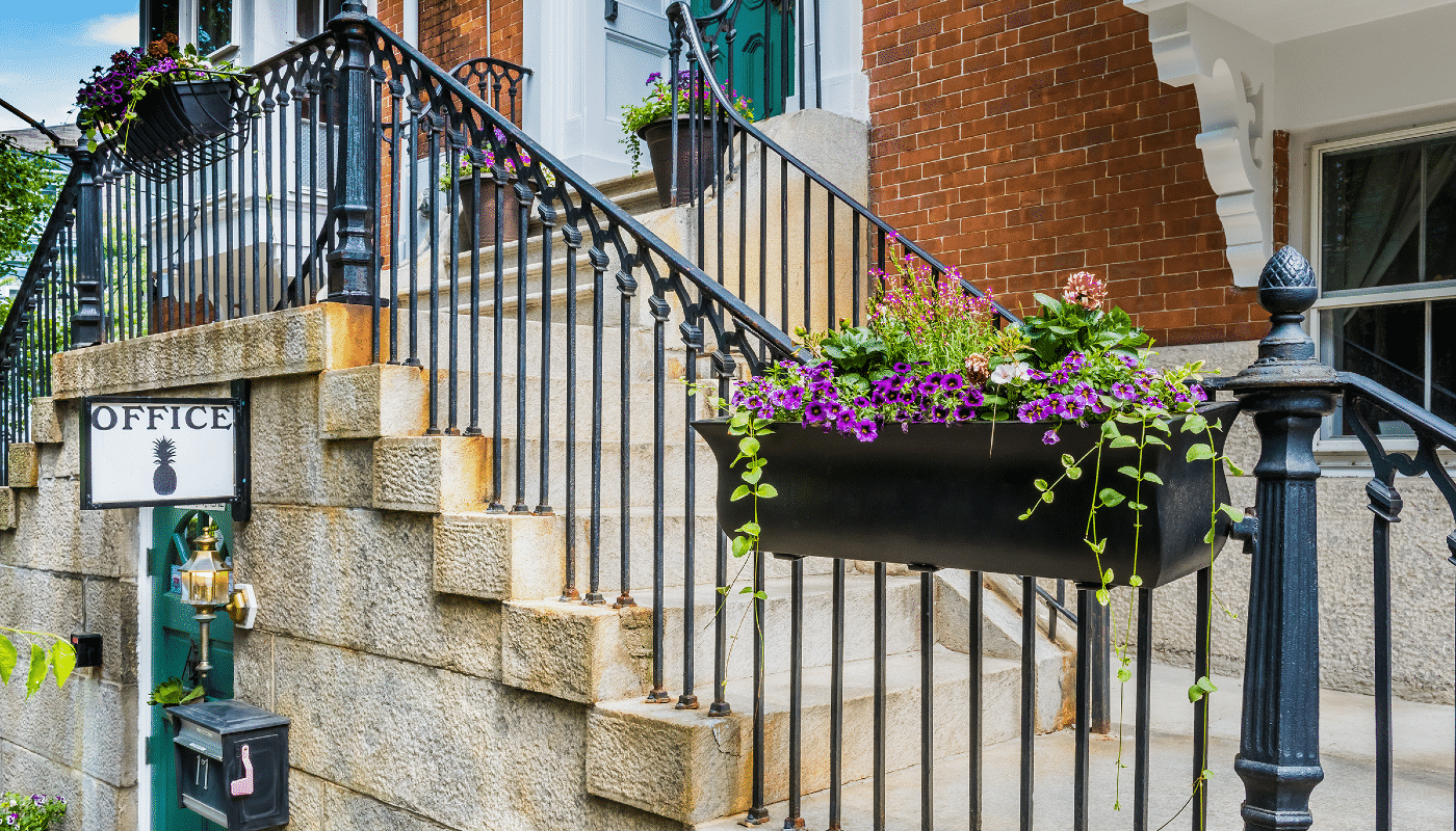 Up close view of the office entrance  showcased by beautiful summer flower boxes.