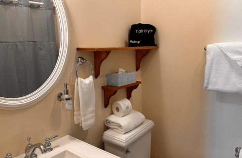 A bathroom with a sink, mirror, and toilet.