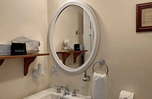 A bathroom with a sink, mirror.