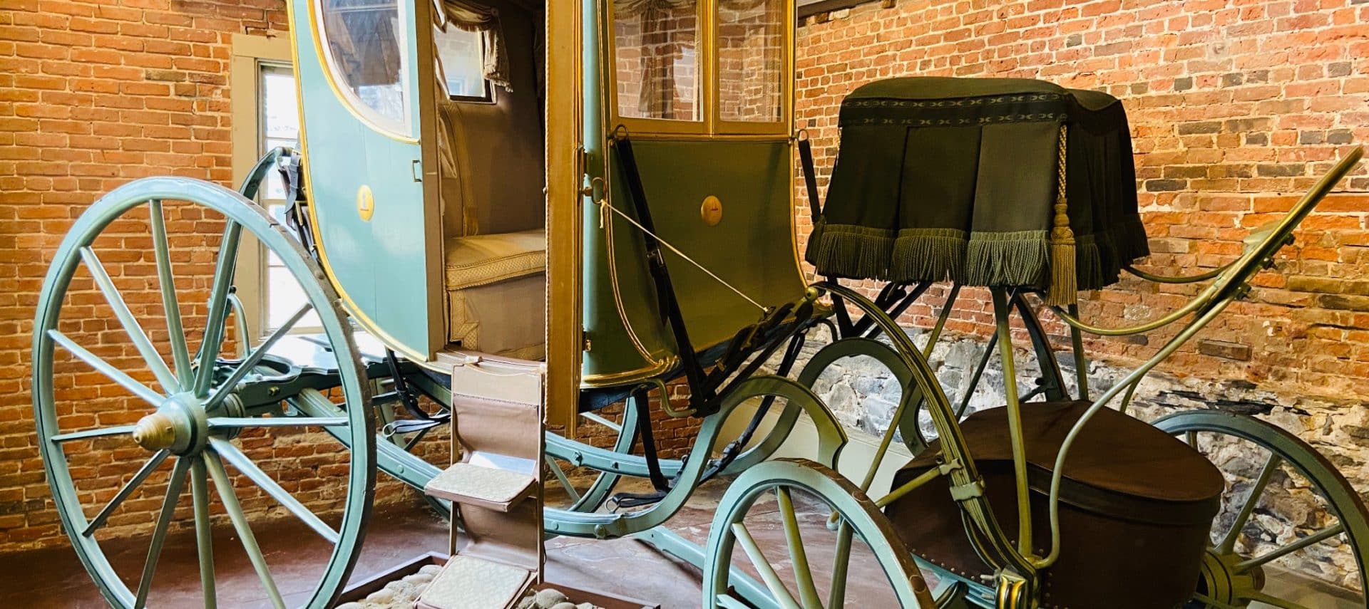 Vintage horse drawn carriage with white leather interior.