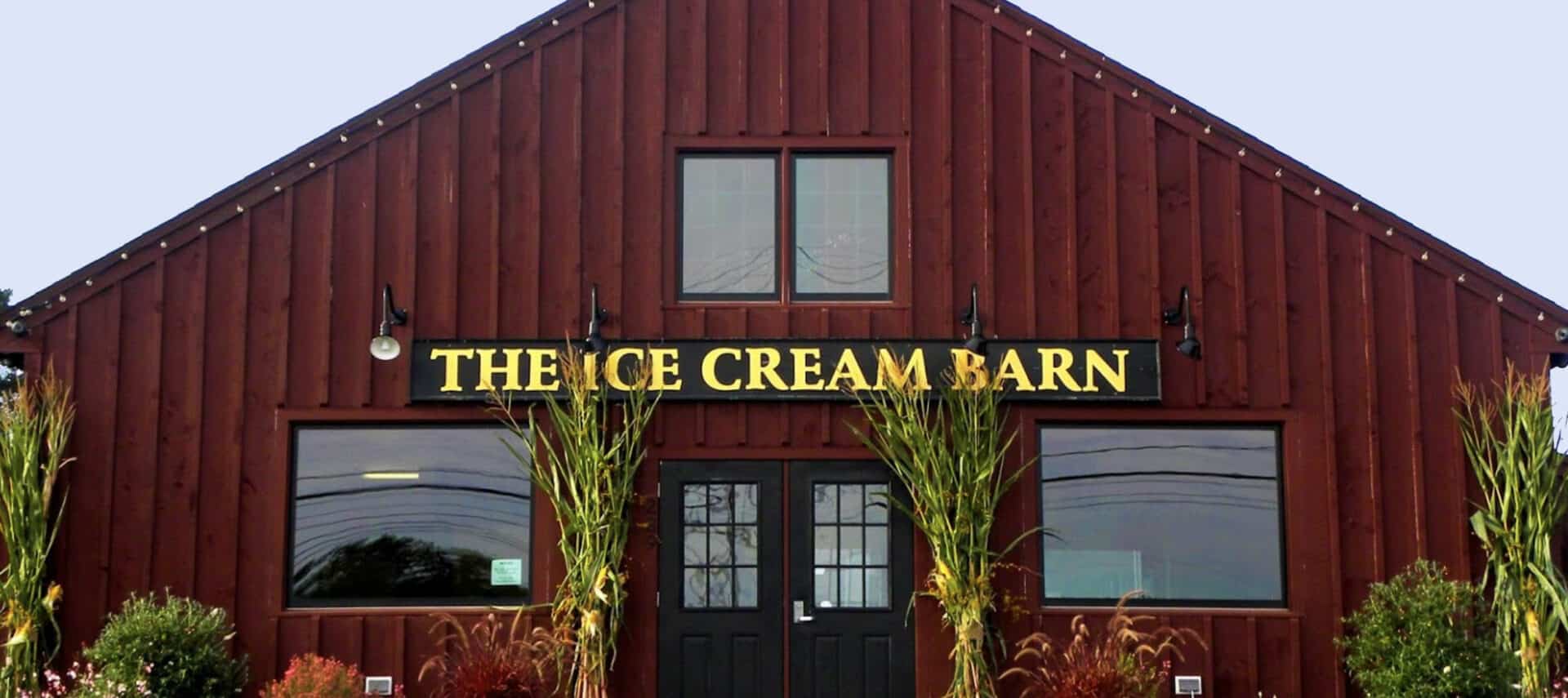 Red barn looking structure with Gold lettering "The Ice Cream Barn".
