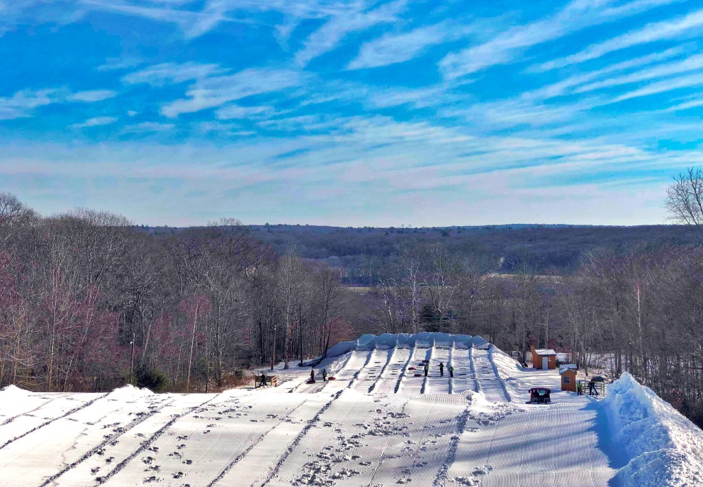 A snowy hillside view of the snow tubing offered at Yawgoo Valley Ski Area