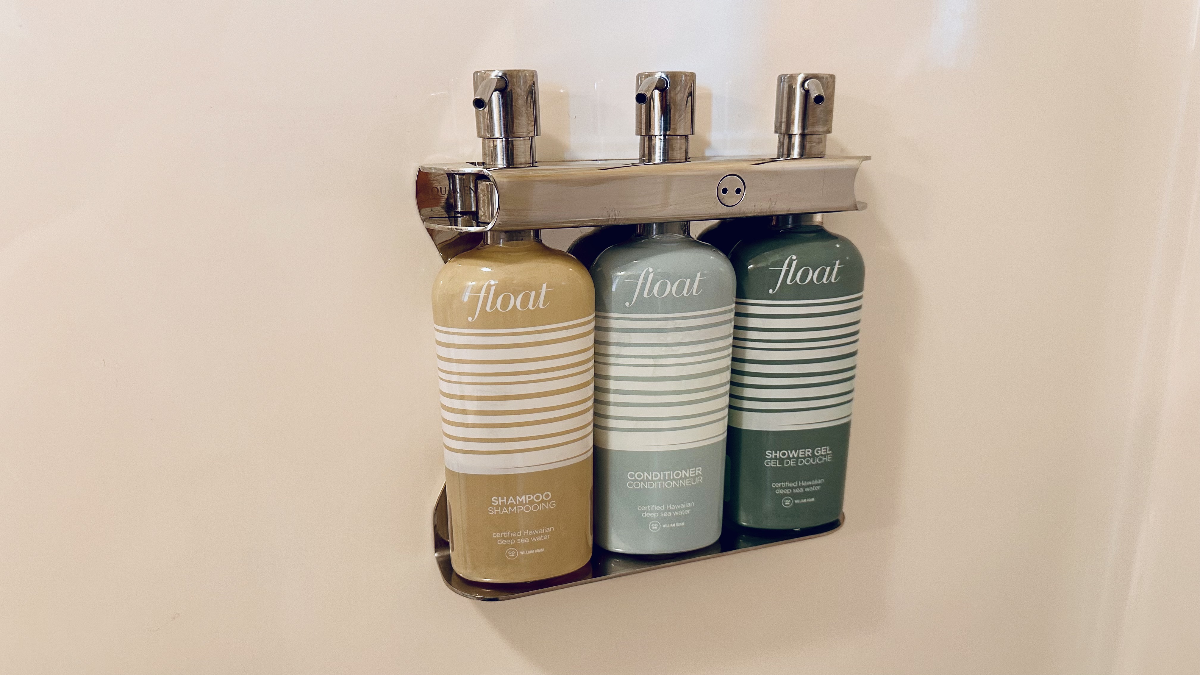 Flowers on a table with personal toiletries in green packaging.