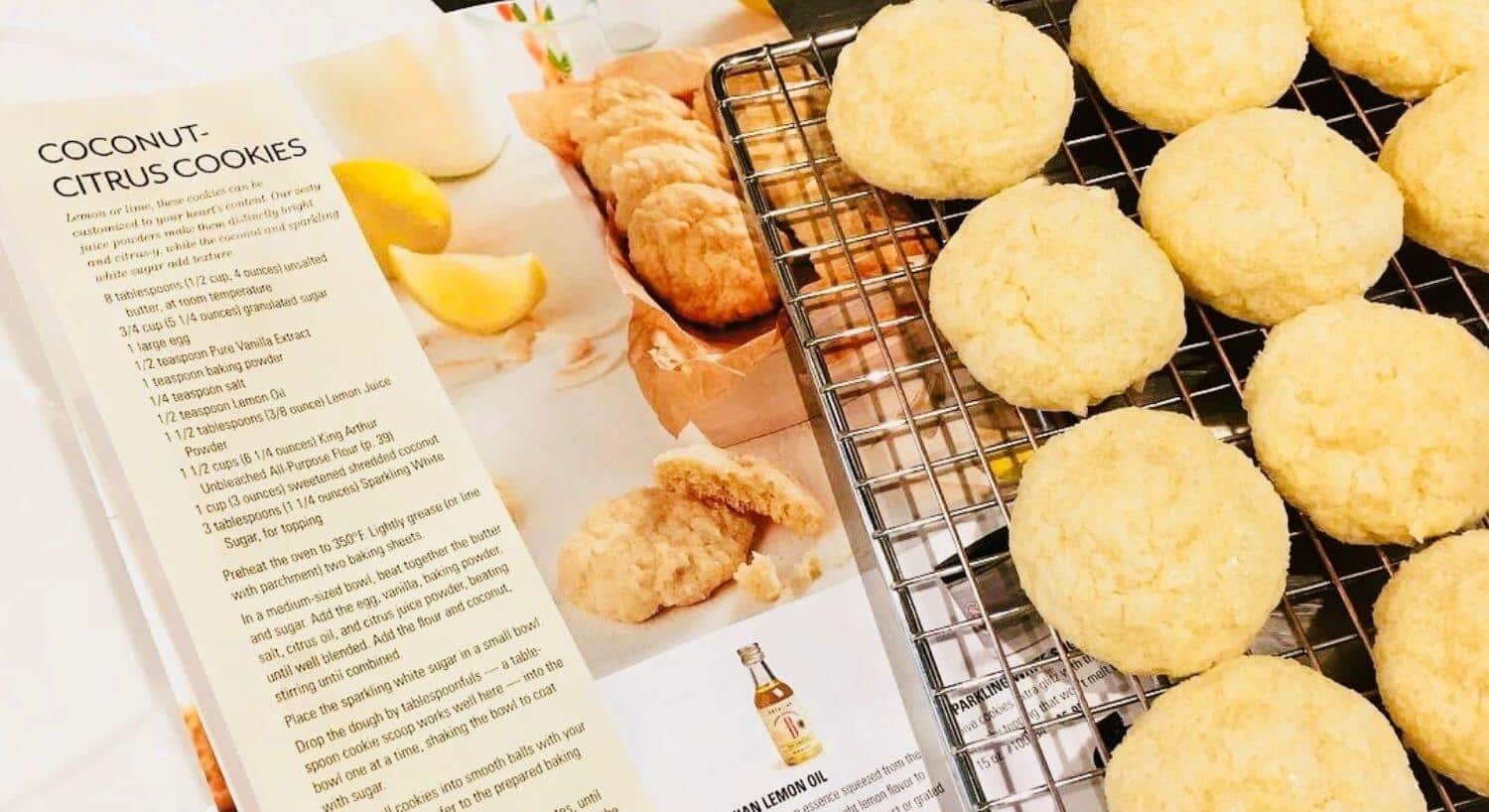 Magazine wiht page open to recipe for lemon cookies next to a wire rack of lemon cookies. 
