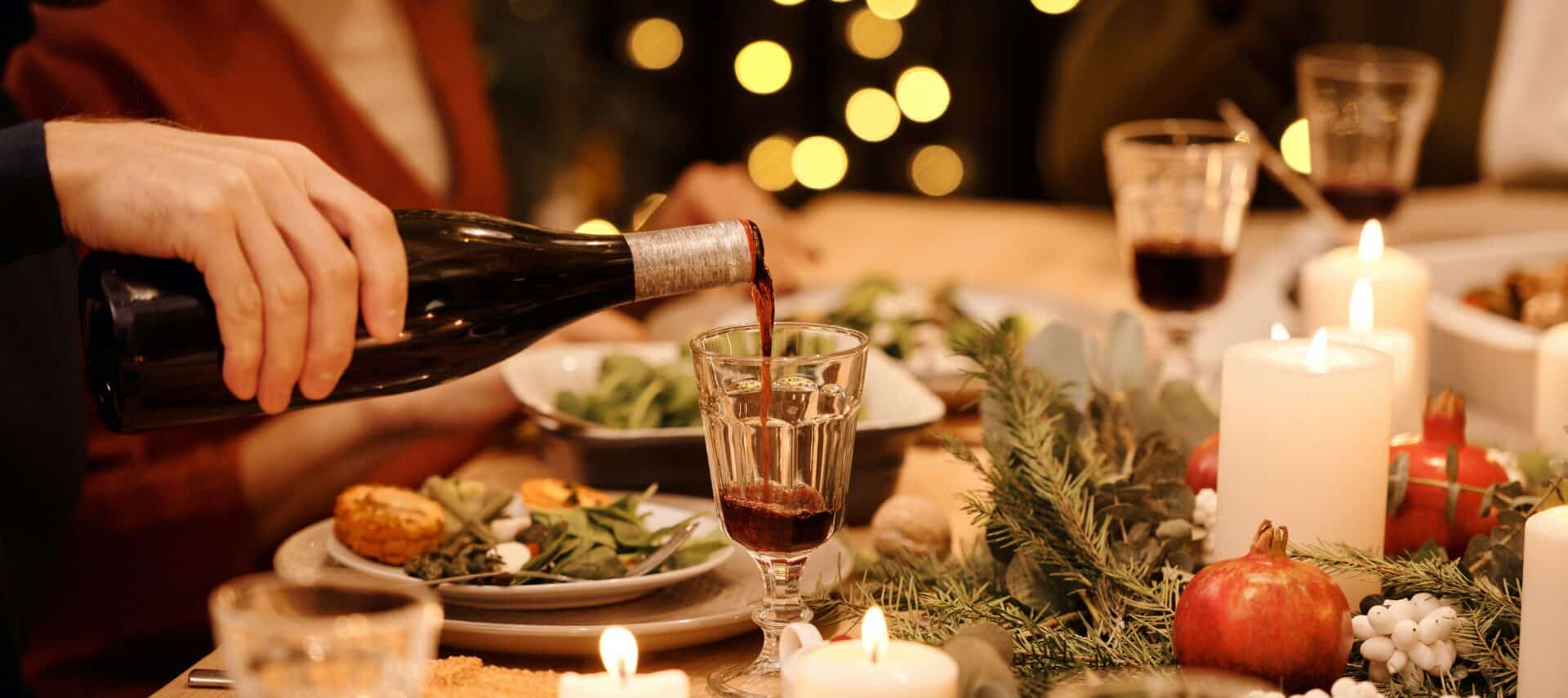 Person pouring red wine into a glass