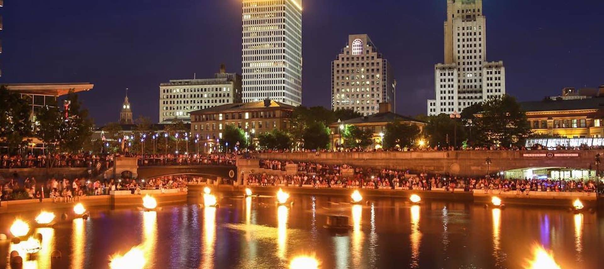 Braziers ignited on the river with the city of Providence in the backdrop.