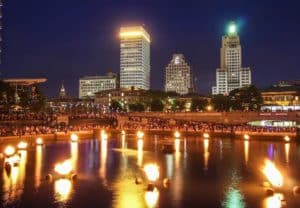 Braziers ignited on the river with the city of Providence in the backdrop.